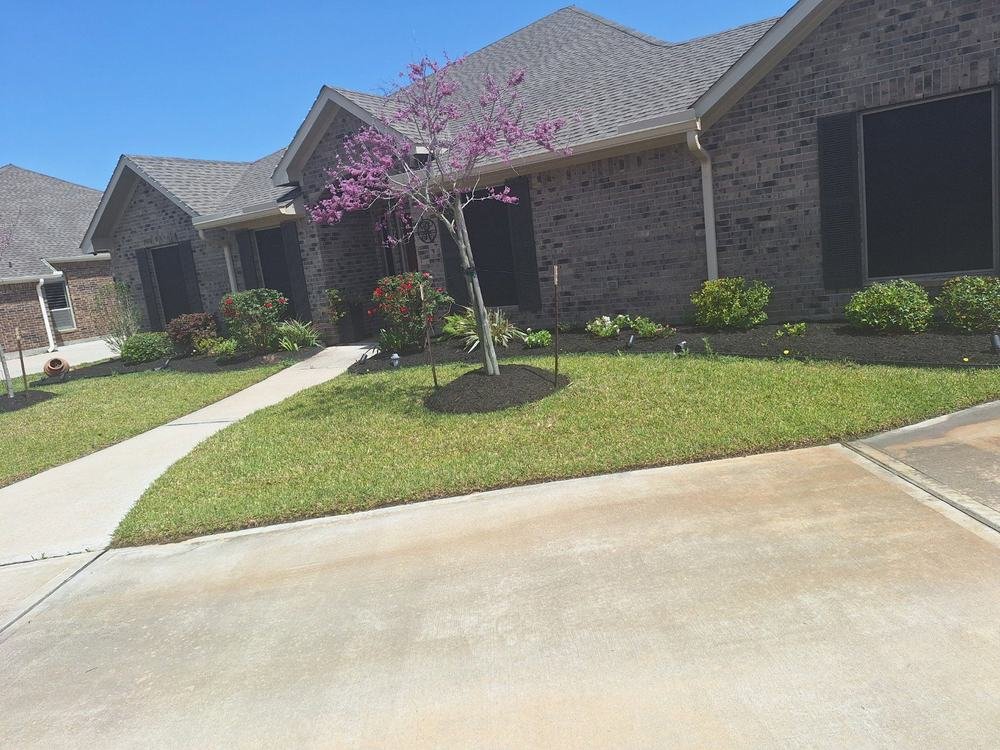Fresh landscaping and dark mulch around a Texas home